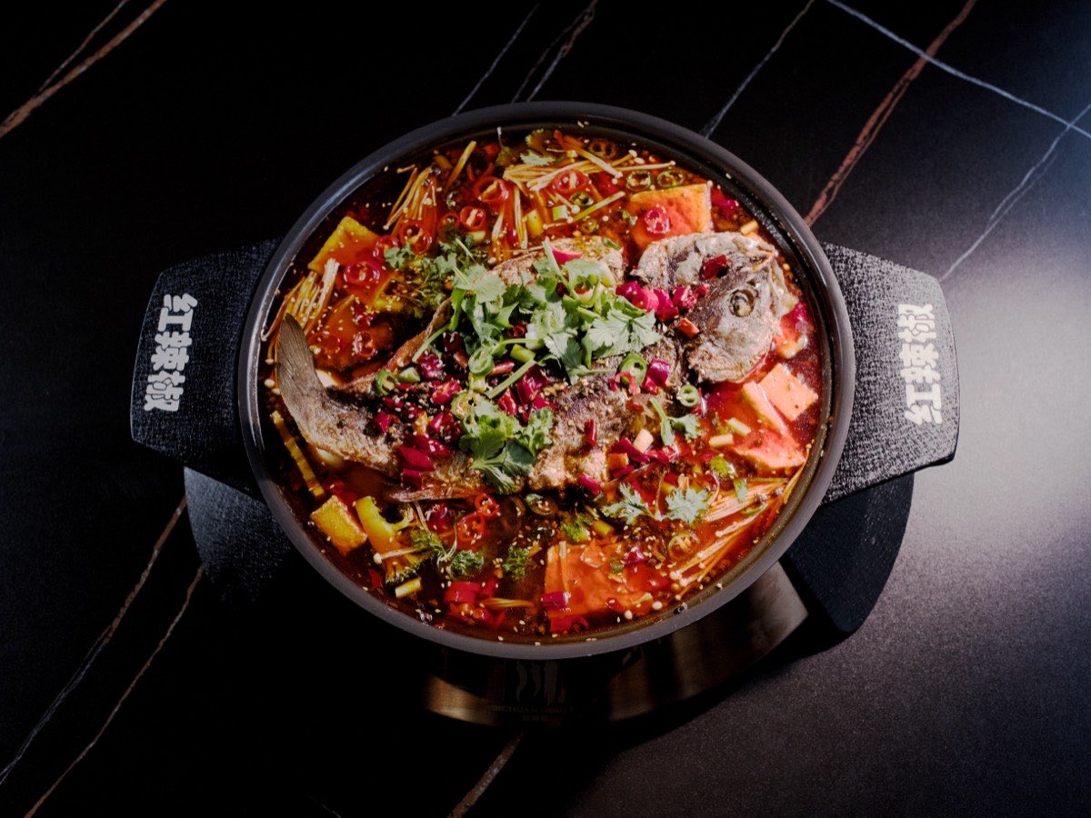 A Sichuan fish hotpot heaped with chilli, coriander and spring onion